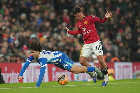 Manchester United's Shea Lacey fouls Brighton's Ferdi Kadioglu during the FA Cup third round soccer match between Manchester United and Brighton in Manchester, England.