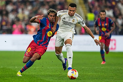 Barcelona's Lamine Yamal, left, duels for the ball with Real Madrid's Kylian Mbappe during the Spanish Super Cup final soccer match at King Abdullah Sports City Stadium in Jeddah, Saudi Arabia.