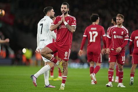 Liverpool's Dominik Szoboszlai reacts after scoring during the FA Cup third round soccer match between Liverpool and Barnsley in Liverpool, England.