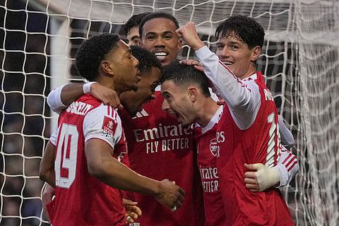 Arsenal players celebrate after a goal during the FA Cup third round soccer match between Portsmouth and Arsenal in Portsmouth, England.