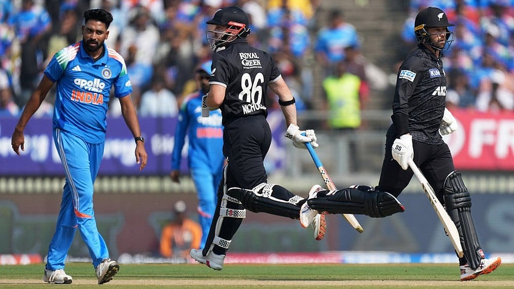 Photo: AP/Ajit Solanki : New Zealand's Devon Conway, right, and batting partner Henry Nicholls run between the wickets as India's Mohammed Siraj, left, looks on during the first One Day International cricket match between India and New Zealand in Vadodara, India.