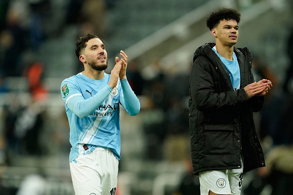 Photo: AP/Dave Thompson : Manchester City's Rayan Cherki, left, and Manchester City's Nico O'Reilly applaud fans at the end of the English League Cup semifinal first leg soccer match between Newcastle and Manchester City in Newcastle, England.