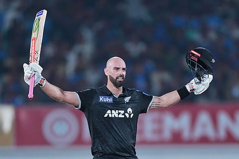 New Zealand's Daryl Mitchell celebrates after scoring a century during the second One Day International cricket match between India and New Zealand in Rajkot, India.