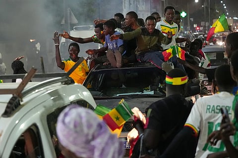 Fans celebrate Senegal's victory semifinal soccer match over Egypt, guaranteeing them a spot in the final of the Africa Cup of Nations (AFCON) 2025 tournament, in Dakar, Senegal.
