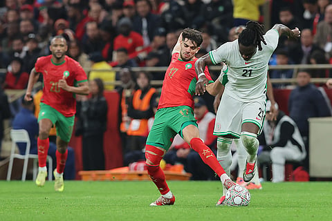 Morocco's Abdessamad Ezzalzouli, left, and Nigeria's Calvin Bassey fight for the ball during the Africa Cup of Nations semi-final match between Nigeria and Morocco in Rabat, Morocco.