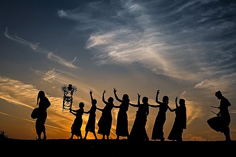 A group of tribal 'Jhumur' folk dancers performs during a procession for immersion of Goddess Tusu as part of 'Tusu' festival celebrations, in Nadia, West Bengal.
