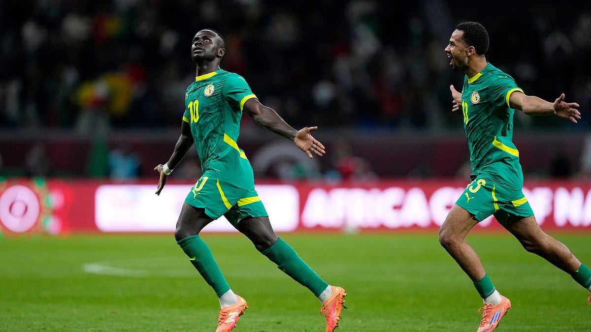 (AP Photo/Themba Hadebe) : Senegal's Sadio Mane, left, celebrates after scoring his side's opening goal during the Africa Cup of Nations semifinal soccer match between Senegal and Egypt, in Tangier, Morocco, Wednesday, Jan. 14, 2026. 