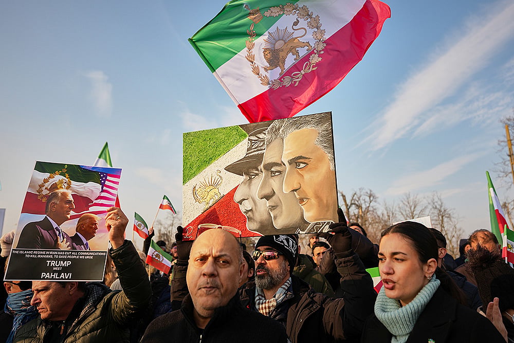  Iranian community hold posters of Irans exiled crown prince Reza Pahlavi in Romania