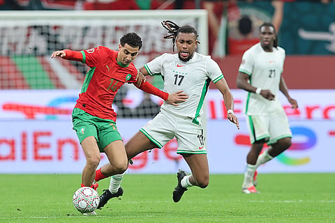 Morocco's Oussama Targhalline, left, and Nigeria's Alex Iwobi fight for the ball during the Africa Cup of Nations semi-final match between Nigeria and Morocco in Rabat, Morocco.	
