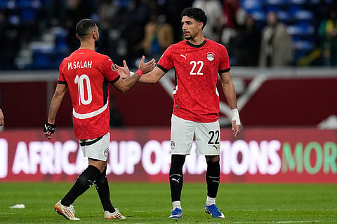 Egypt's Mohamed Salah, left, shakes hands with Egypt's Omar Marmoush after the Africa Cup of Nations semifinal soccer match between Senegal and Egypt, in Tangier, Morocco.