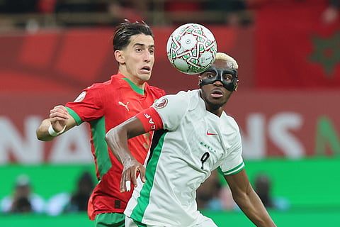 Morocco's Nayef Aguerd, left, and Nigeria's Victor Osimhen fight for the ball during the Africa Cup of Nations semi-final match between Nigeria and Morocco in Rabat, Morocco.