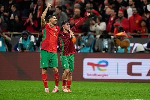 Morocco's Achraf Hakimi, left, and Brahim Abdelkader Díaz celebrate after winning the penalty shootout during the Africa Cup of Nations semi-final match between Nigeria and Morocco in Rabat, Morocco.