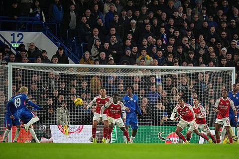 Chelsea's Alejandro Garnacho, left, scores his side's second goal during the English League Cup semifinal first leg soccer match between Chelsea and Arsenal in London.