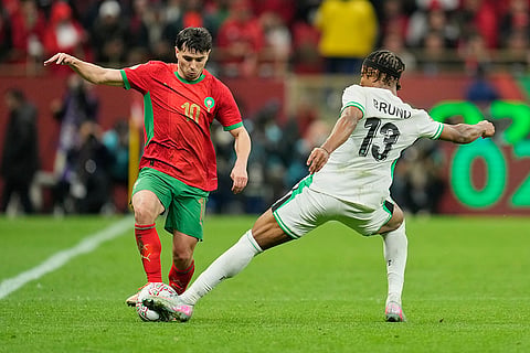 Morocco's Brahim Abdelkader Díaz , left, and Nigeria's Bruno Onyemaechi fight for the ball during the Africa Cup of Nations semi-final match between Nigeria and Morocco in Rabat, Morocco.