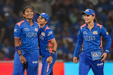 Mumbai Indians' Sajeevan Sajana, left, celebrates with teammates after taking the catch of UP Warriorz' Kiran Navgire during the Women's Premier League (WPL) 2026 T20 cricket match between Mumbai Indians and UP Warriorz, at the DY Patil Stadium, in Navi Mumbai.