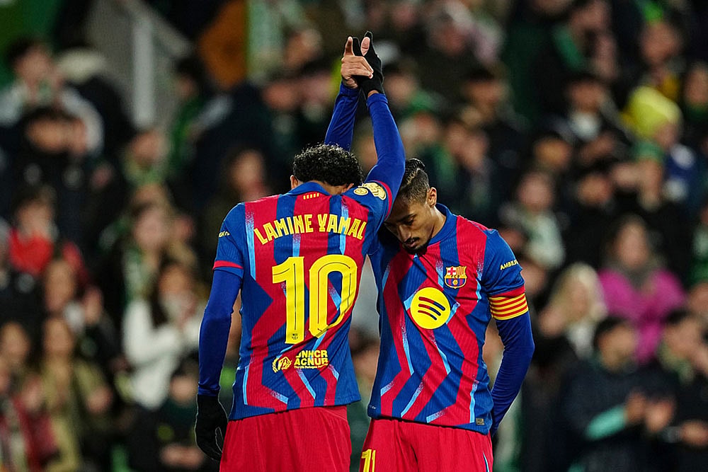 | Photo: AP/Miguel Oses : Barcelona's Lamine Yamal, left, celebrates after scoring his side's second goal with his teammate Barcelona's Raphinha during the Copa del Rey round of 16 soccer match between Racing Santander and Barcelona, in Santander, Spain.