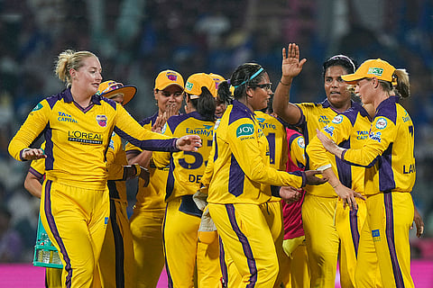 UP Warriorz players celebrate after the wicket of Mumbai Indians' captain Harmanpreet Kaur during the Women's Premier League (WPL) T20 cricket match between Mumbai Indians and UP Warriorz, at the DY Patil Stadium in Navi Mumbai.