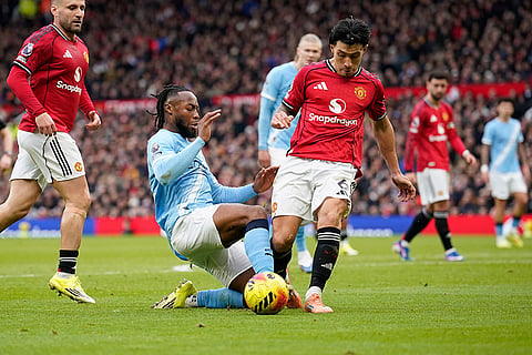 Manchester City's Antoine Semenyo, centre, challenges for the ball with Manchester United's Lisandro Martinez, centre right, during the English Premier League soccer match between Manchester United and Manchester City in Manchester, England.