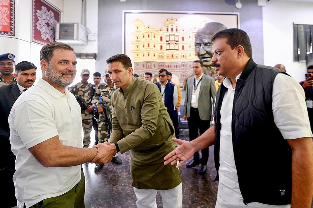 | Photo: PTI : LoP in the Lok Sabha and Congress leader Rahul Gandhi, left, meets LoP in the Madhya Pradesh assembly Umang Singhar, right, and state party President Jitu Patwari, upon his arrival at Devi Ahilyabai Holkar International airport, in Indore.