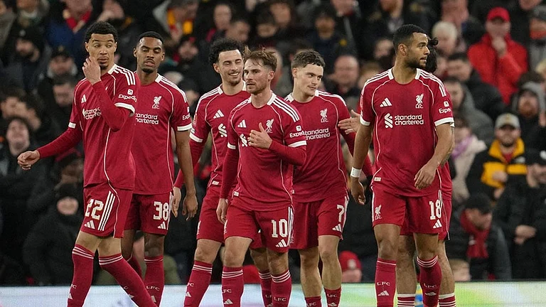 Premier League: Liverpool players walk to the ceneter after scoring during the FA Cup third round soccer match between Liverpool and Barnsley in Liverpool, England. - | Photo: AP/Jon Super