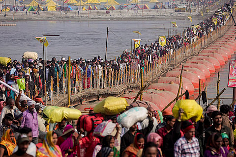 People crowd a floating pontoon bridge to take a holy dip ahead of the 'Mauni Amavasya' festival during the Magh Mela, in Prayagraj.
