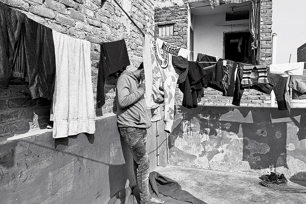 | Photo: Mrinalini Dhyani : Life, Altered: Mohammad Iqbal stands in the balcony of his mother-in-law’s house in one of the localities of North-east Delhi