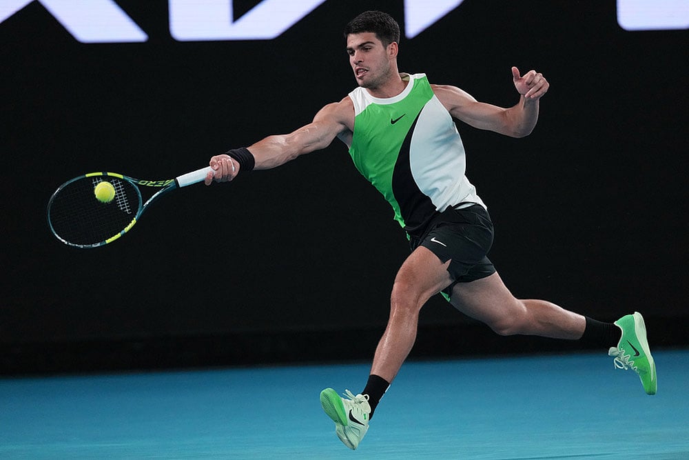 Carlos Alcaraz of Spain plays a forehand return to Adam Walton of Australia