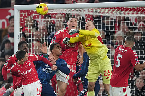 Nottingham Forest's goalkeeper Matz Sels leaps for the ball during the English Premier League soccer match between Nottingham Forest and Arsenal in Nottingham, England.