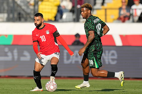Egypt's Mohamed Salah is challenged by Nigeria's Raphael Onyedika during the Africa Cup of Nations third place game between Egypt and Nigeria in Casablanca, Morocco.