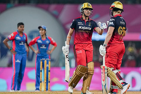 Royal Challengers Bengaluru's captain Smriti Mandhana, left, and Georgia Voll during the Women's Premier League (WPL) T20 cricket match between Royal Challengers Bengaluru and Delhi Capitals, at the DY Patil Stadium, in Navi Mumbai.