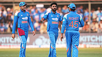 Photo: AP : India's Mohammed Siraj, centre, celebrates with teammates the wicket of New Zealand's Daryl Mitchell during the third ODI in Indore.