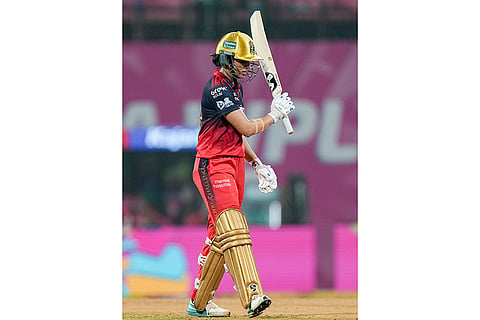 Royal Challengers Bengaluru's captain Smriti Mandhana celebrates her half-century during the Women's Premier League (WPL) T20 cricket match between Royal Challengers Bengaluru and Delhi Capitals, at the DY Patil Stadium, in Navi Mumbai.