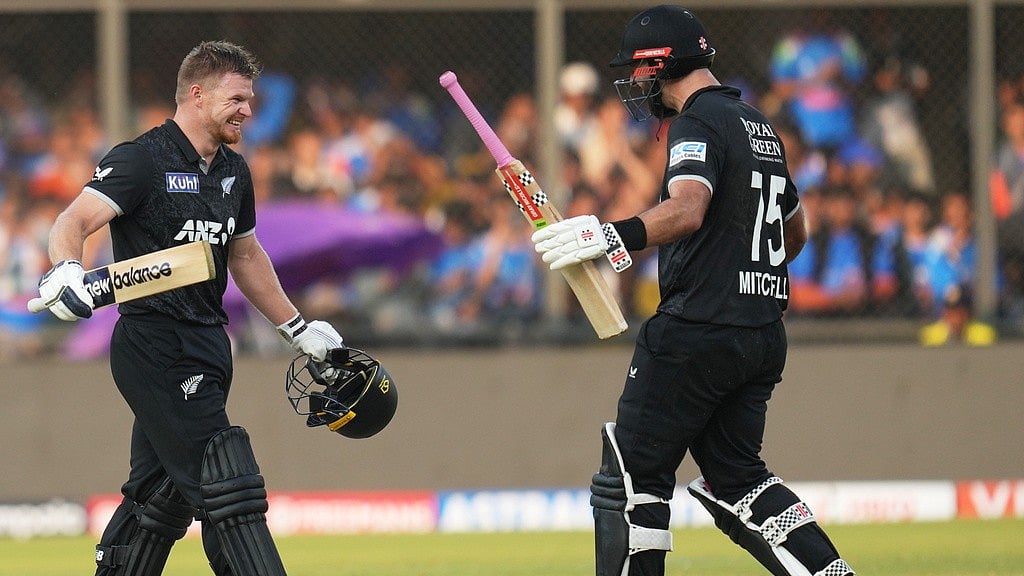 AP : New Zealand's Glenn Phillips, left, walks towards batting partner Daryl Mitchell to celebrate his century during the third One Day International cricket match between India and New Zealand in Indore