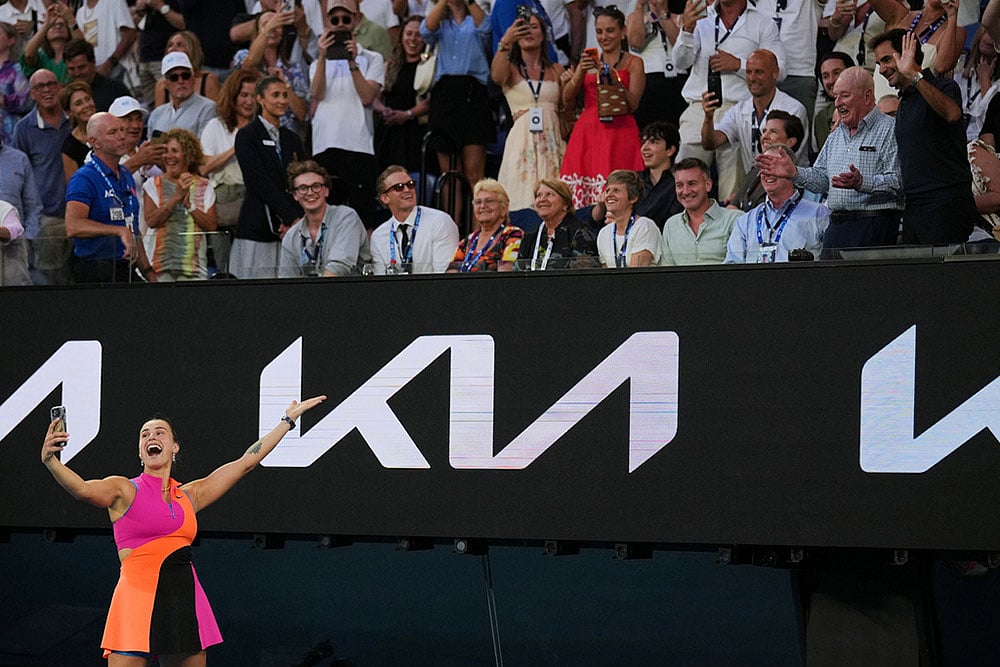 Aryna Sabalenka of Belarus takes a selfie with Rod Laver, second right, and Roger Federer