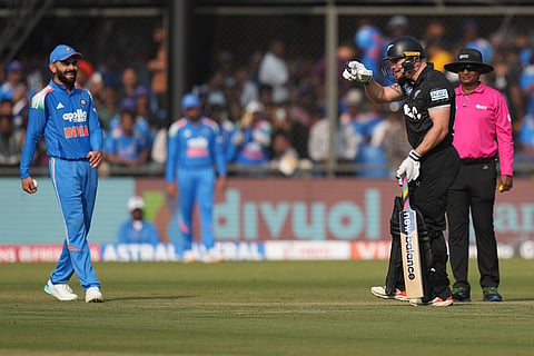 New Zealand's Glenn Phillips, right, shares a lighter moment with India's Virat Kohli during the third One Day International cricket match between India and New Zealand in Indore, India.