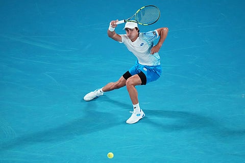 Adam Walton of Australia plays a forehand return to Carlos Alcaraz of Spain during their first round match at the Australian Open tennis championship in Melbourne, Australia.