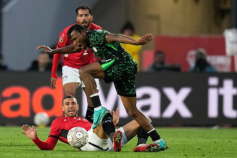 Egypt's Ramy Rabiaa, bottom, vies for the ball with Nigeria's Samuel Chukwueze during the Africa Cup of Nations third place game between Egypt and Nigeria in Casablanca, Morocco.