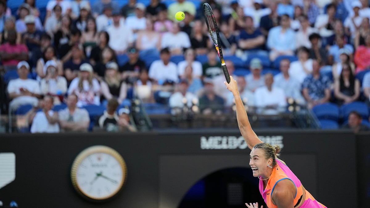 AP : Aryna Sabalenka of Belarus serves to Tiantsoa Rakotomanga Rajaonah of France during their first round match at the Australian Open tennis championship.