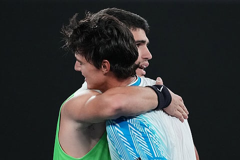 Carlos Alcaraz of Spain is congratulated by Adam Walton of Australia following their first round match at the Australian Open tennis championship in Melbourne, Australia.