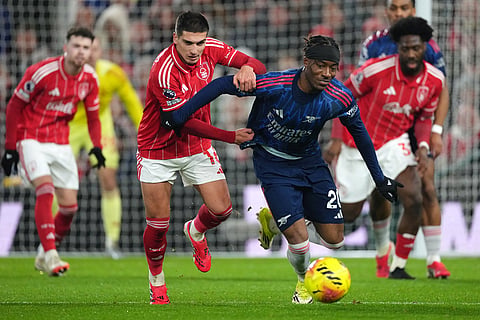 Nottingham Forest's Nicolas Dominguez, left, fights for the ball with Arsenal's Noni Madueke during the English Premier League soccer match between Nottingham Forest and Arsenal in Nottingham, England.