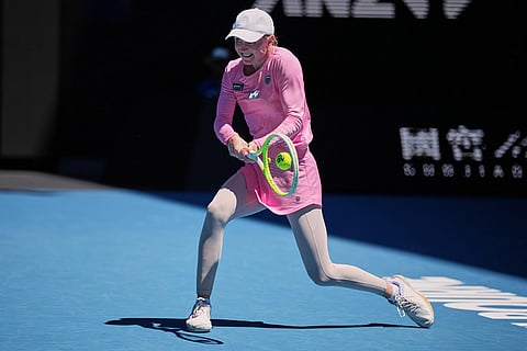 Aliaksandra Sasnovich of Belarus plays a backhand return to Jasmine Paolini of Italy during their first round match at the Australian Open tennis championship in Melbourne, Australia.