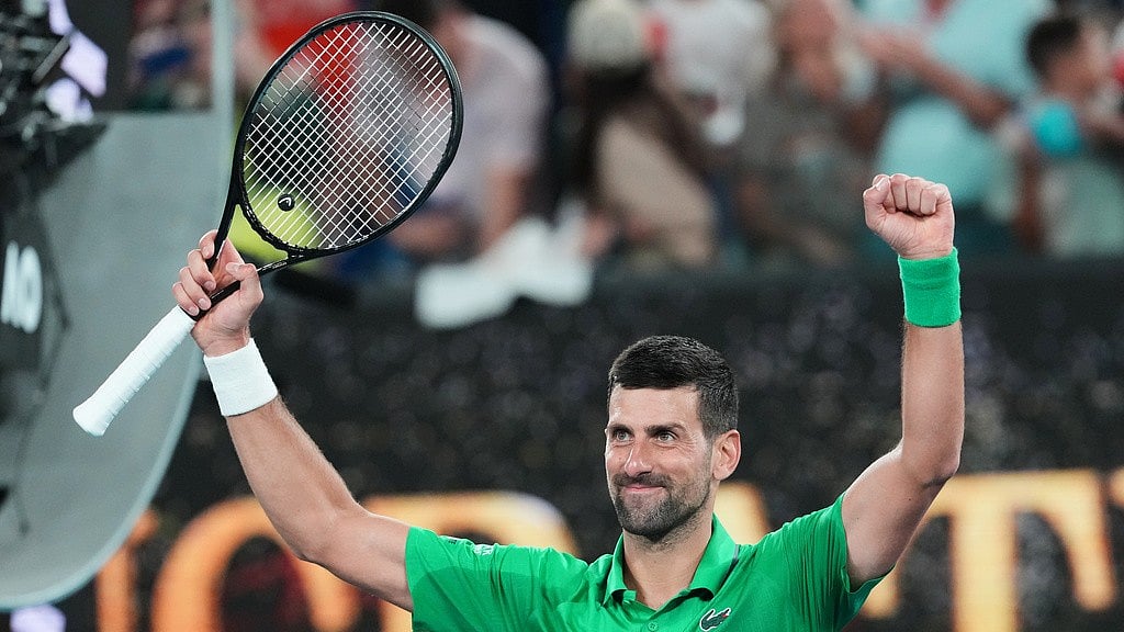 Photo: AP : Novak Djokovic of Serbia celebrates after defeating Pedro Martinez of Spain in their first round match at the Australian Open tennis championship in Melbourne.