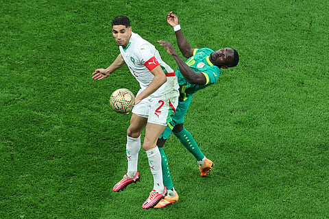 Morocco's Achraf Hakimi, left, and Senegal's Sadio Mane battle for the ball during the Africa Cup of Nations final soccer match between Senegal and Morocco in Rabat, Morocco.