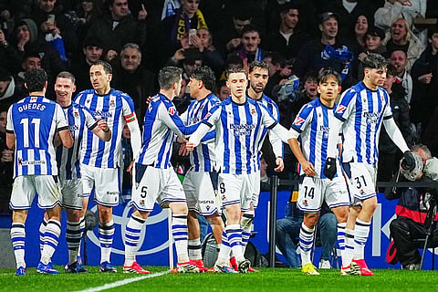 Real Sociedad players celebrate after Real Sociedad's Mikel Oyarzabal scored his side's opening goal during the Spanish La Liga soccer match between Real Sociedad and Barcelona in San Sebastian, Spain.