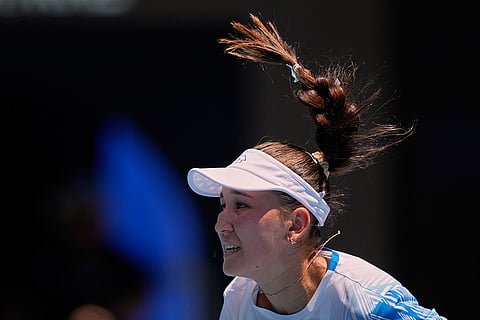 Kamilla Rakhimova of Uzbekistan serves to Coco Gauff of the U.S. during their first round match at the Australian Open tennis championship in Melbourne, Australia.
