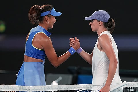 Iga Swiatek, right, of Poland is congratulated by Yuan Yue, left, of China following their first round match at the Australian Open tennis championship in Melbourne, Australia.