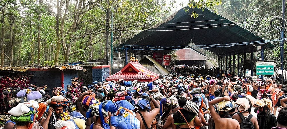 | Photo: PTI : Devotees carry ‘Irumudi’ during the 'Vrischikam' after the Sabarimala temple opened for 'Mandala-Makaravilakku' pilgrimage season, in Pathanamthitta.