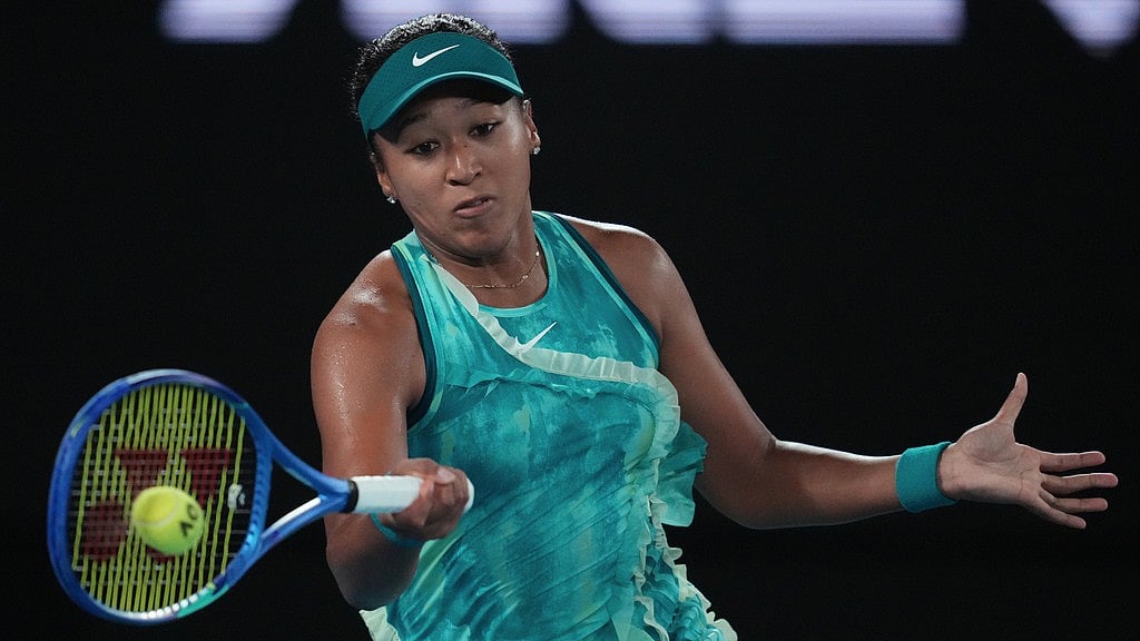 Photo: AP : Naomi Osaka of Japan plays a forehand return to Antonia Ruzic of Croatia during their first round match at the Australian Open tennis championship in Melbourne.