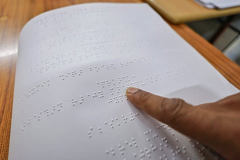 A person reads a page printed in Braille, at 'Braille Samachar Patra', in Jaipur. The newspaper published in Braille script from Jaipur is gradually becoming a lifeline for a large number of visually impaired people. 