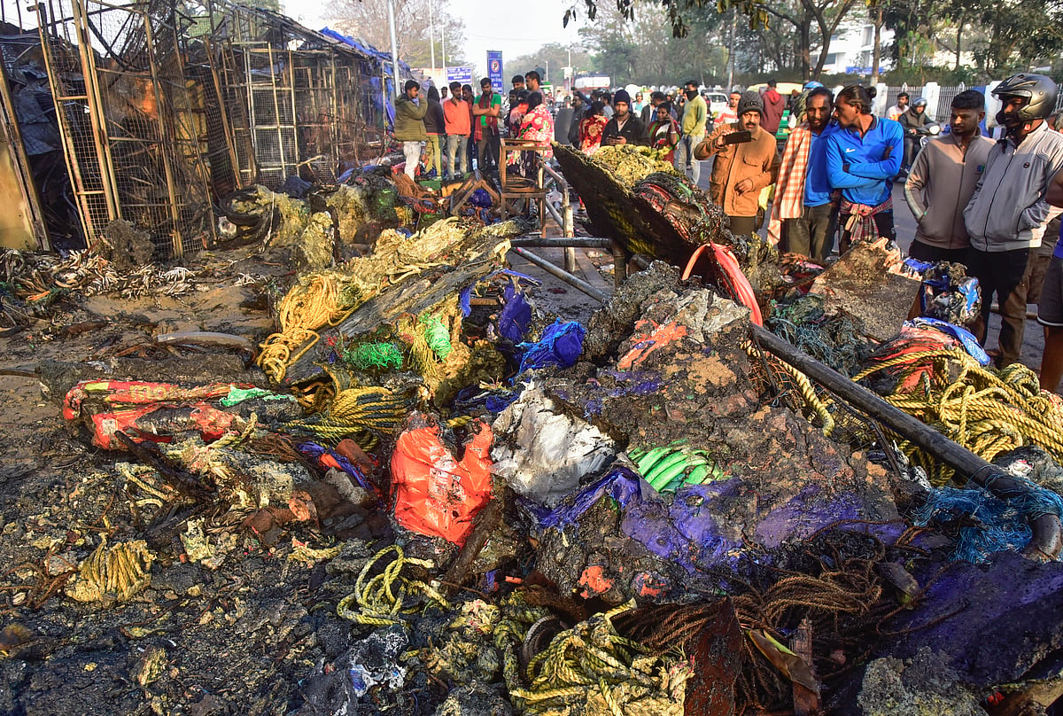 Bhubaneswar: Locals gather near charred remains of shops after a major fire incident at Unit-I Haat, in Bhubaneswar, Tuesday, Jan. 20, 2026. Over 40 shops were gutted in the fire that broke out late Monday night.
Source: PTI